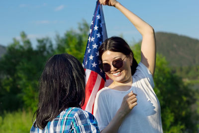 Women with usa flag, celebration of patriotic american national holiday 4th of july independence day
