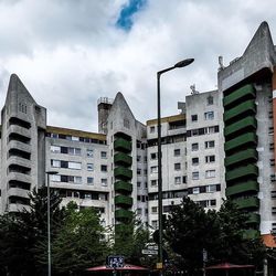 Low angle view of building against cloudy sky