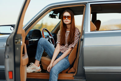 Portrait of woman sitting in car