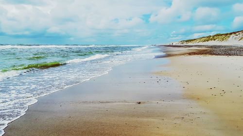 Scenic view of sea against cloudy sky