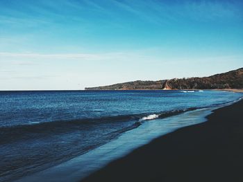 Scenic view of sea against blue sky