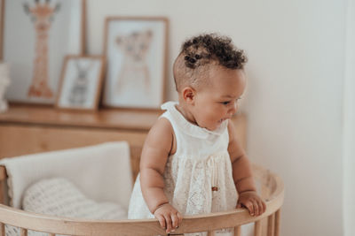 Cute baby girl sitting at home