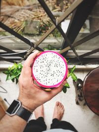 High angle view of man holding drink