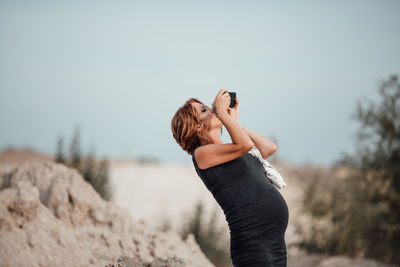 Woman photographing with mobile phone