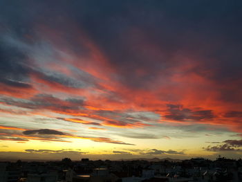 Silhouette buildings against sky during sunset