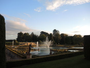 View of fountain in garden against sky