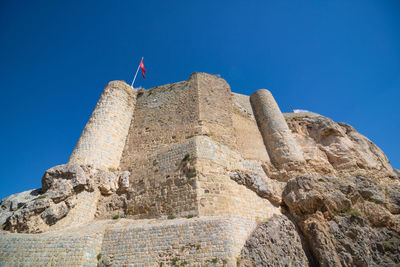 Low angle view of fort against blue sky