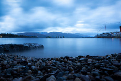 Scenic view of bay against blue sky