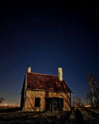 Low angle view of old building against sky at night