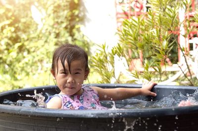 Portrait of cute boy against water