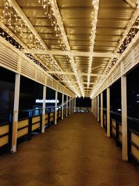 Empty corridor in illuminated building