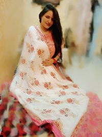 Portrait of a smiling young woman standing outdoors