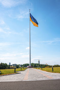 Bicolor blue and yellow national flag of ukraine waving in wind against sky