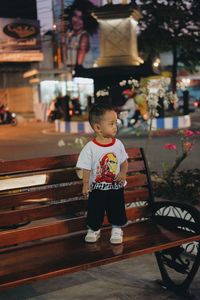 Full length of cute boy looking away