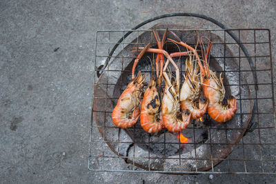 High angle view of meat on barbecue grill