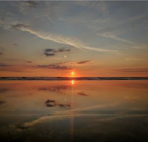 Scenic view of beach against sky during sunset