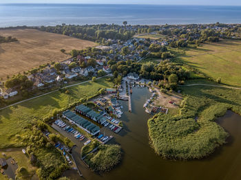 High angle view of trees and buildings on field