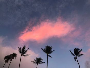 Low angle view of silhouette palm trees against romantic sky