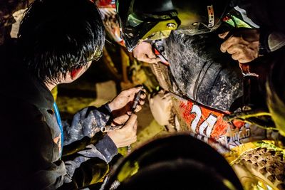 High angle view of people working on motorcycle