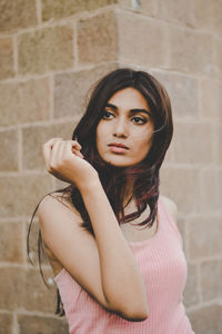 Portrait of woman against wall