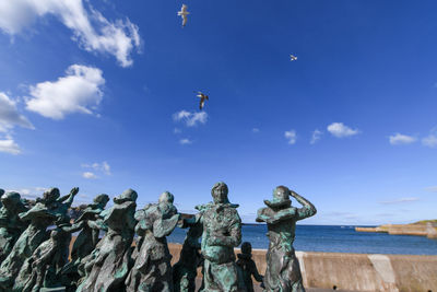 Low angle view of statue against blue sky