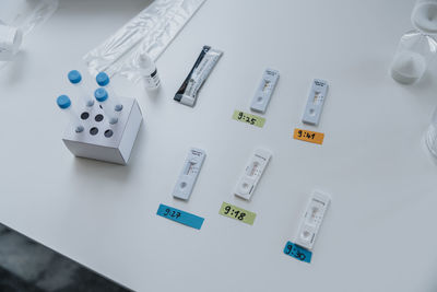 Variation of rapid diagnostic test cassettes with time sticker on table at clinic