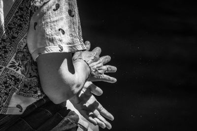 Midsection of woman dusting hands outdoors