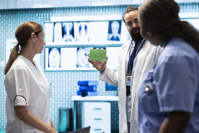 Side view of female friends standing in laboratory