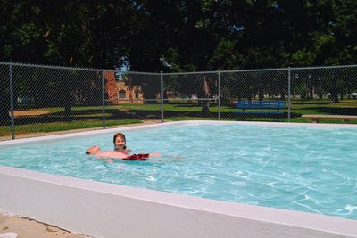 Siblings playing in swimming pool