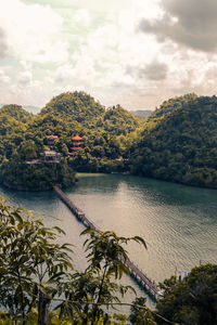 Scenic view of river by trees against sky