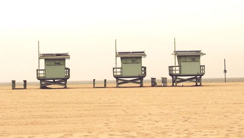 Lifeguard hut on beach against clear sky