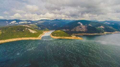 Scenic view of lake and mountains against sky