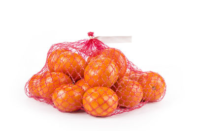 Close-up of orange fruit against white background