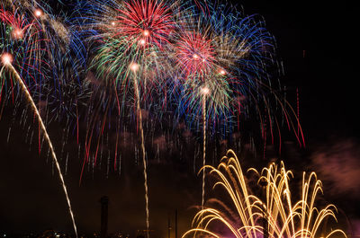 Low angle view of firework display at night