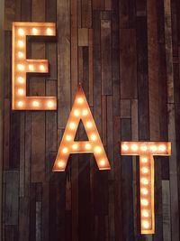 Illuminated eat text on wall