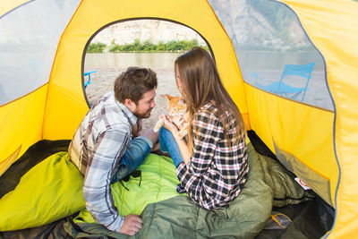Rear view of young couple in tent