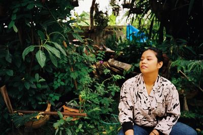 Young woman looking at plants