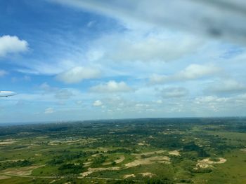 Scenic view of landscape against cloudy sky