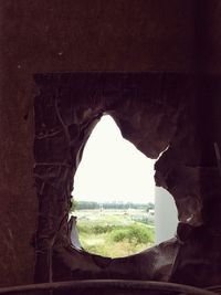 Scenic view of landscape against clear sky seen through arch