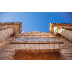 Low angle view of building against clear blue sky