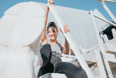 Low angle view of woman sitting on chair