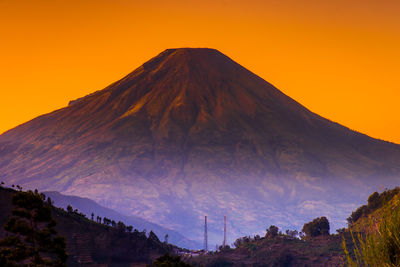 Panoramic view of volcanic mountain against sky during sunset