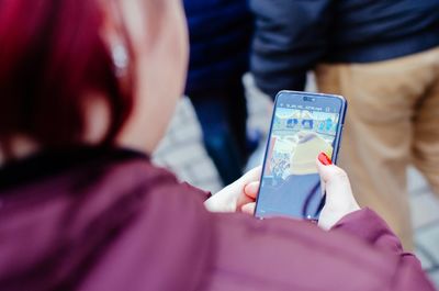 Midsection of woman using mobile phone