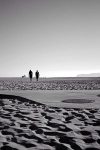 People on beach against sky