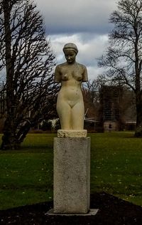 Statue in park against sky