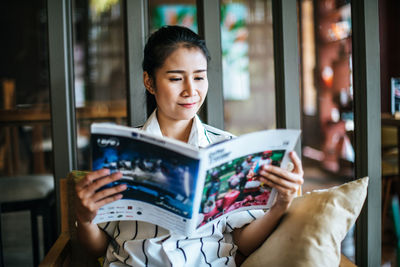 Young woman reading book