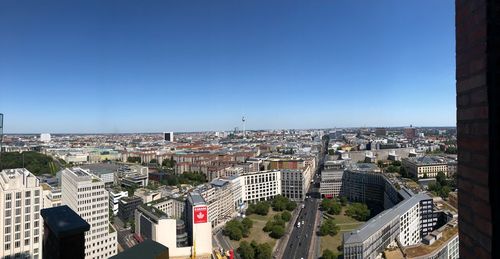 High angle view of buildings against clear blue sky