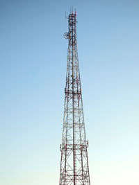 Low angle view of communications tower against sky