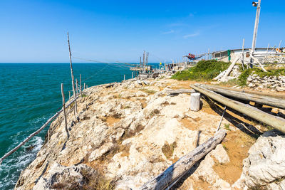 Scenic view of beach against blue sky