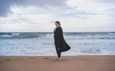 Full length of man on beach against sky